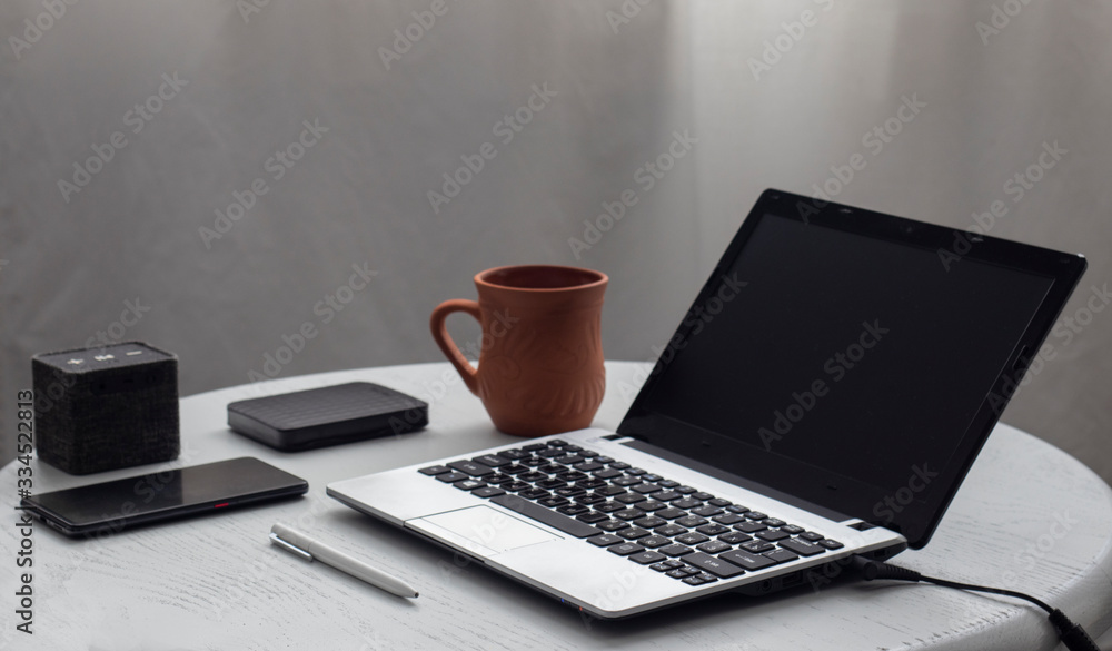 laptop and cup of coffee on the table - obrazy, fototapety, plakaty 
