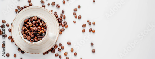 Fotografie, Tablou Cup of coffee and coffee beans on a white background with copy space for your text