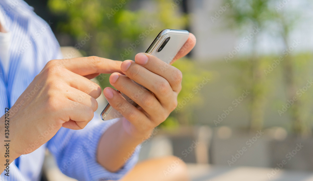 close up hand hold mobile cell phone device to communicated with friend and family or using application in quarantine time concept close up hand hold mobile cell phone device to communicated with friend and family or using application in quarantine time concept
