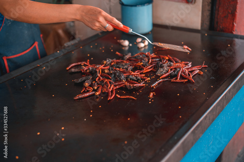 Red fried grasshoppers with chili peppers in Mexico