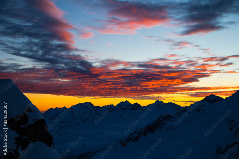Colorful winter sunset on the top of Mons Avium Peak in Switzerland.