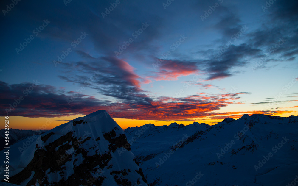 Colorful winter sunset on the top of Mons Avium Peak in Switzerland.