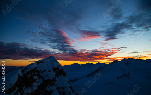 Obraz na płótnie Colorful winter sunset on the top of Mons Avium Peak in Switzerland. w salonie