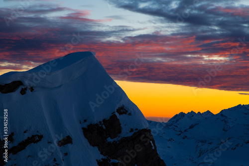 Obraz na płótnie Colorful winter sunset on the top of Mons Avium Peak in Switzerland. w salonie