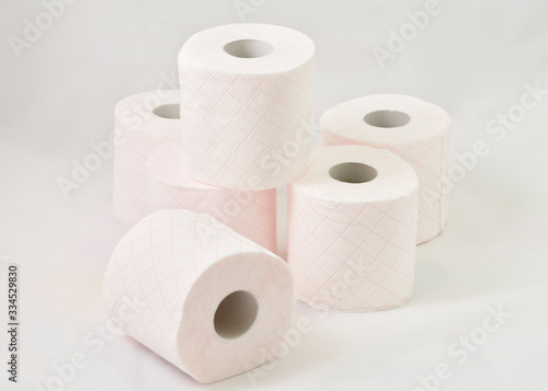 toilet paper rolls piled on white background