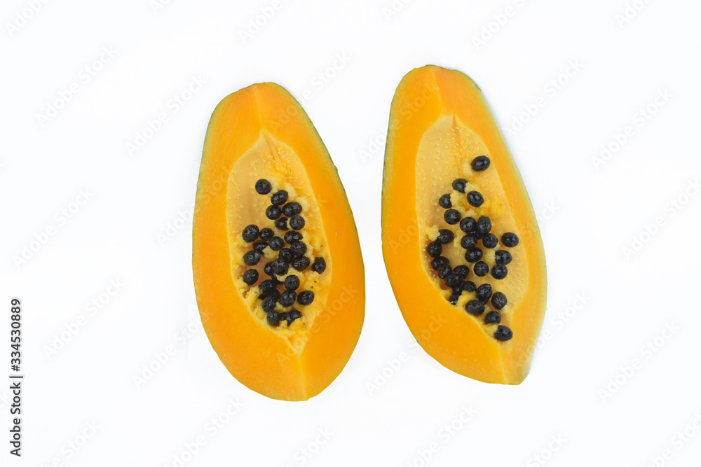 couple of sliced pieces of fresh yellow ripe papaya fruit isolated before a white background couple of sliced pieces of fresh yellow ripe papaya fruit isolated before a white background