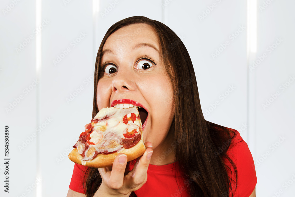 Young beautiful woman eat fast food pizza and smiles Young beautiful woman eat fast food pizza and smiles