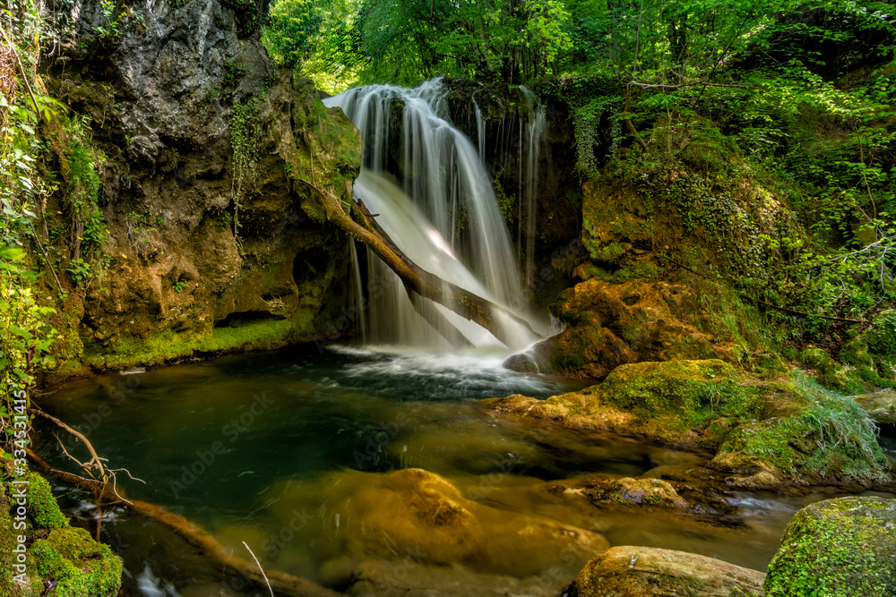 Long exposure of the beautiful La Vaioaga waterfall with green moss, Beusnita, Cheile Nerei National Park, Caras Severin, Romania