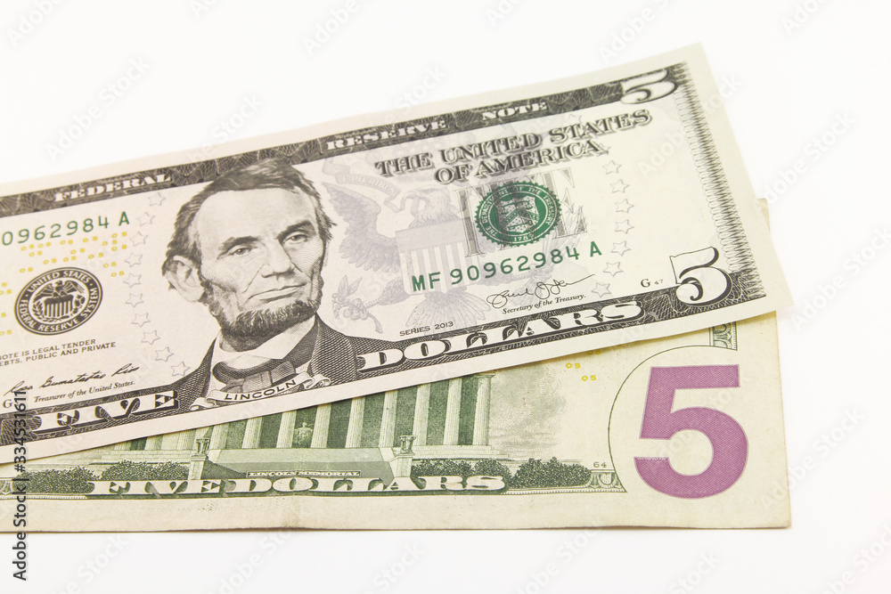 Five dollar bills in cash on white background Five dollar bills in cash on white background