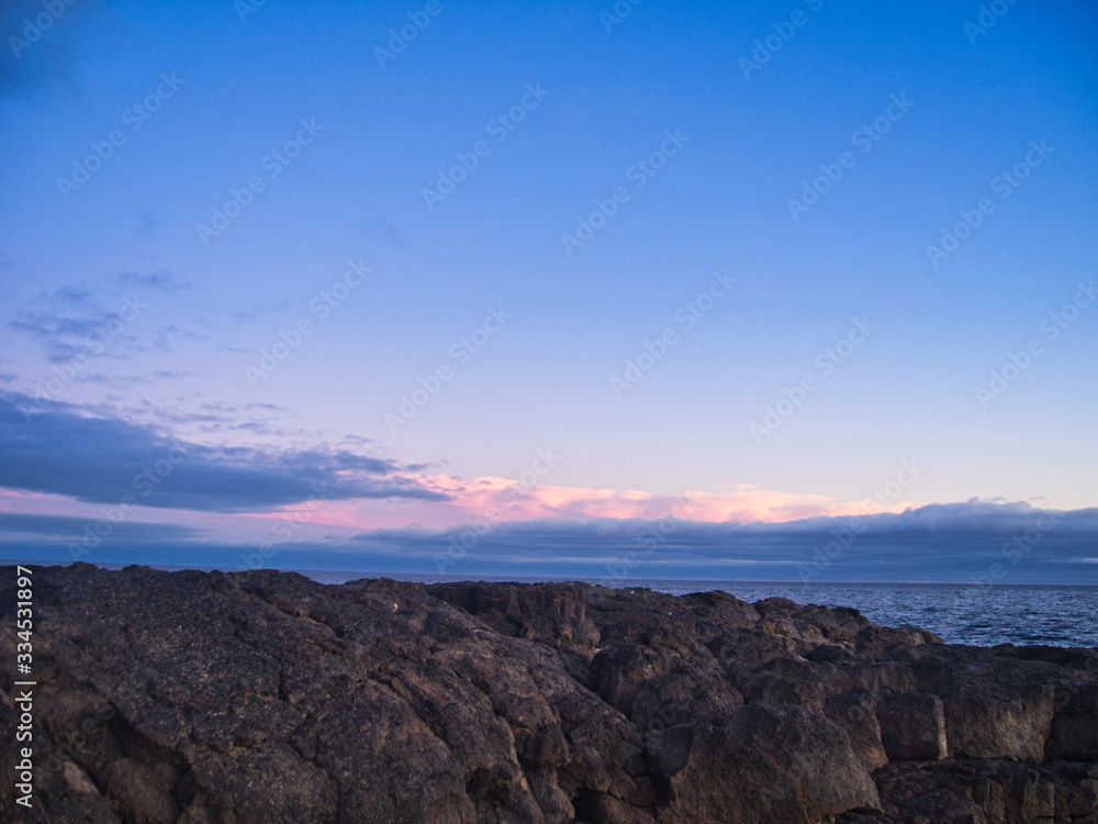 Sunset rocks and a light sky with gentle lights