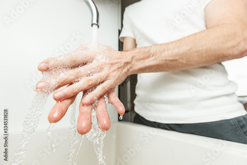 Man washing his hands sanitizing clean