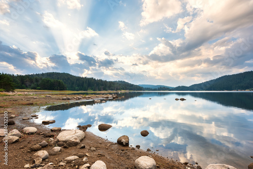 Beautiful morning view with dramatic sky over a mountain lake. Shiroka Polyana dam in Rhodopi Mountains, Bulgaria. photo