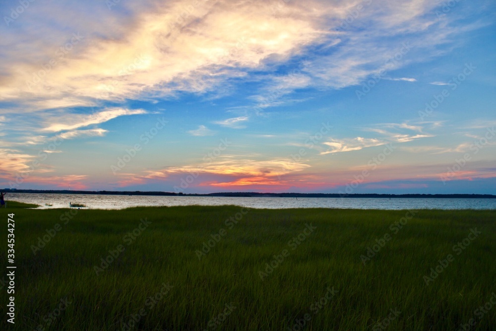 sunset over green field