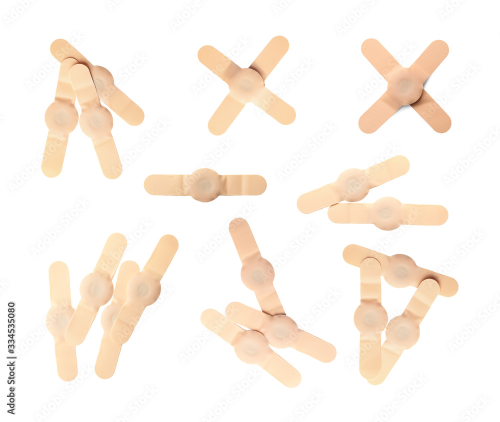 Set with sticking plasters on white background, top view Set with sticking plasters on white background, top view