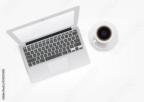 Modern white laptop with coffee cup. Top view