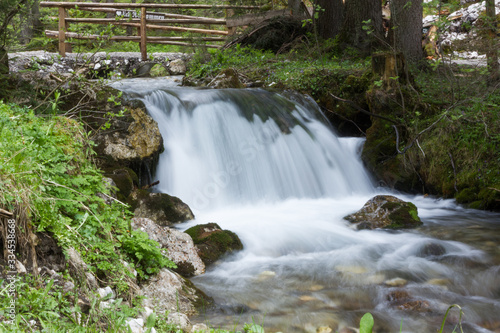 Fototapeta Naklejka Na Ścianę i Meble -  Calming small waterfall on a mountain stream in the Austrian Alps
