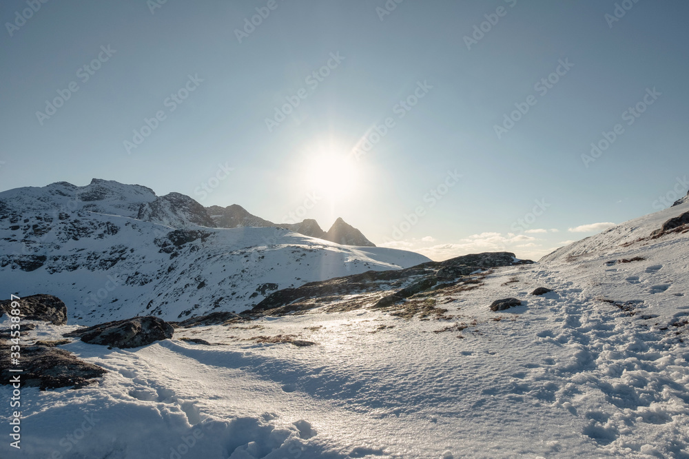 Sunset shining over snowy hill on Ryten mount