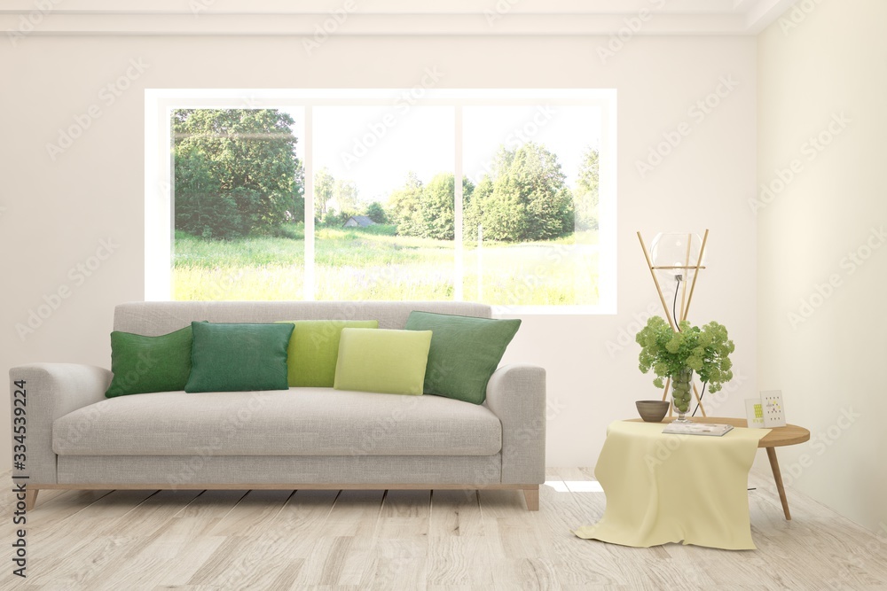 Fototapeta premium White living room with sofa and summer landscape in window. Scandinavian interior design. 3D illustration
