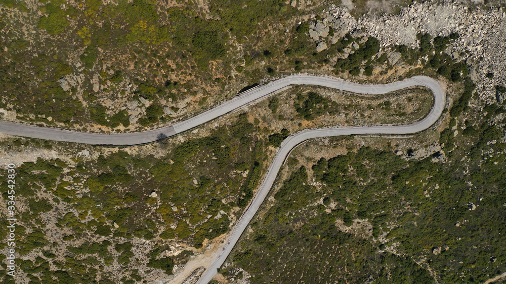 Aerial drone top down photo of snake winding mountain asphalt road as seen at spring