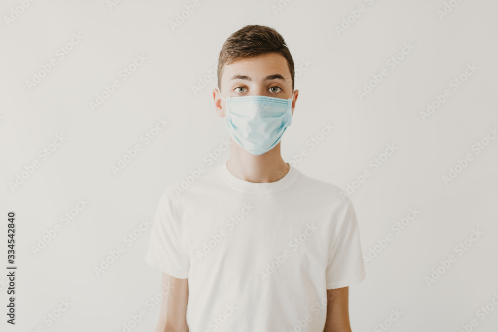 A young man wearing a medical mask to prevent infection, airborne respiratory disease, coronavirus isolated on a white background