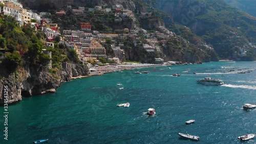 Aerial panorama view of Positano, Luxury yachts, boats and hotels, apartments overlooking Tyrrhenian Sea. Arrival of water transport in the bay, tourist route, travel tour concept. Positano, Italy