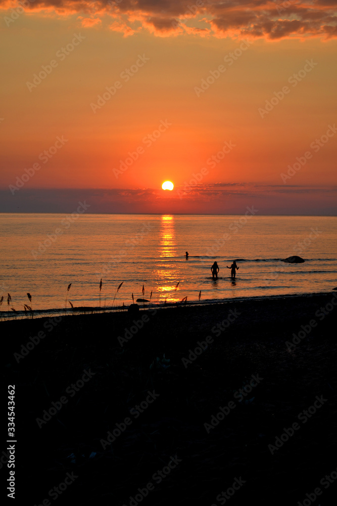 Warm red summer sunset on the Baltic sea with calm and relaxing water. Warm red summer sunset on the Baltic sea with calm and relaxing water.
