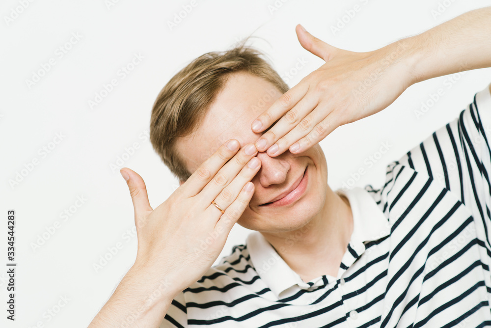 Man closes eyes with her hands Man closes eyes with her hands