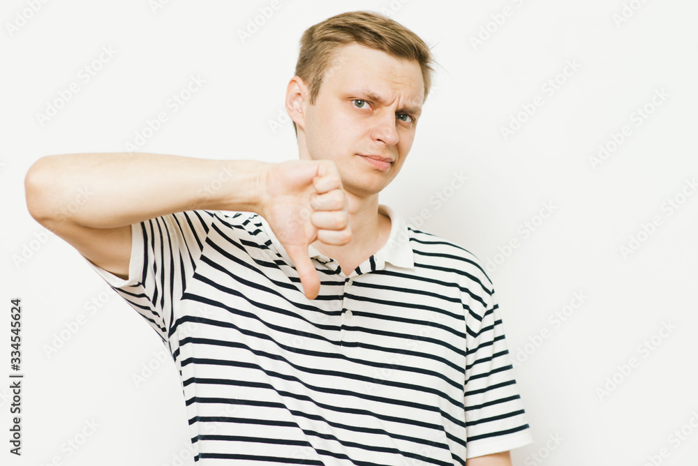 man showing a thumb down gesture man showing a thumb down gesture