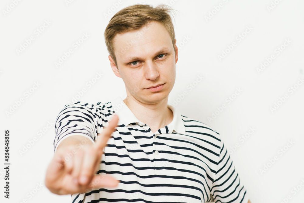 Young european male model is pushing a digital touch screen . Young european male model is pushing a digital touch screen .