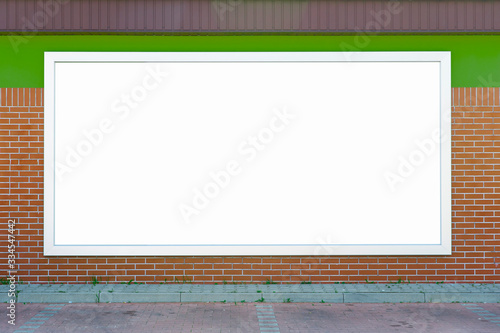 Blank billboard mounted on the brick wall.