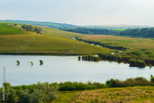 Green fields of farmland on a hilly terrain photo