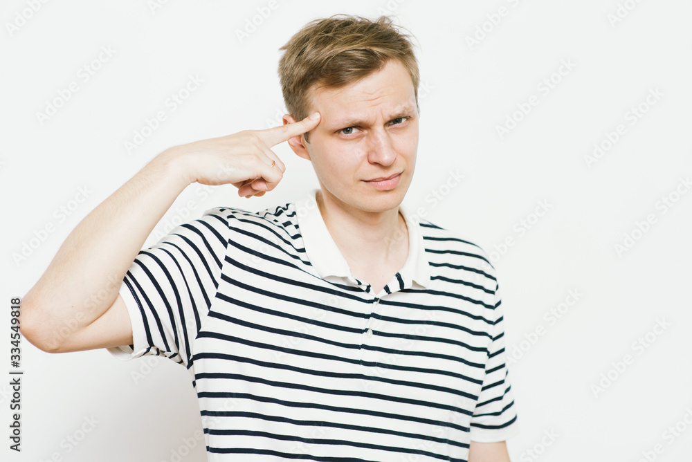 Closeup portrait of angry man gesturing with his finger against his temple, are you crazy? Closeup portrait of angry man gesturing with his finger against his temple, are you crazy?