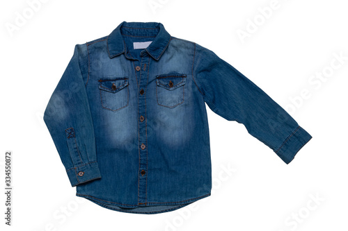 Denim shirts isolated. Close-up of a male stylish faded blue jeans shirt for kids isolated on a white background. Long sleeve shirt summer fashion.