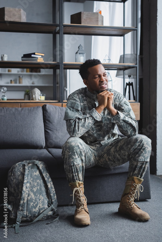 sad african american soldier in military uniform suffering from PTSD at home © LIGHTFIELD STUDIOS
