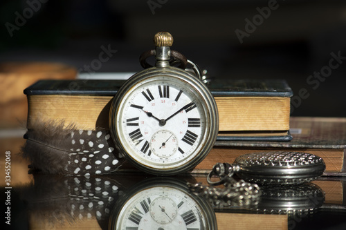 old pocket watch and book