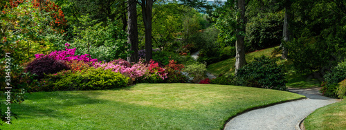 Fotografija Beautiful Garden with blooming trees during spring time, Wales, , banner size