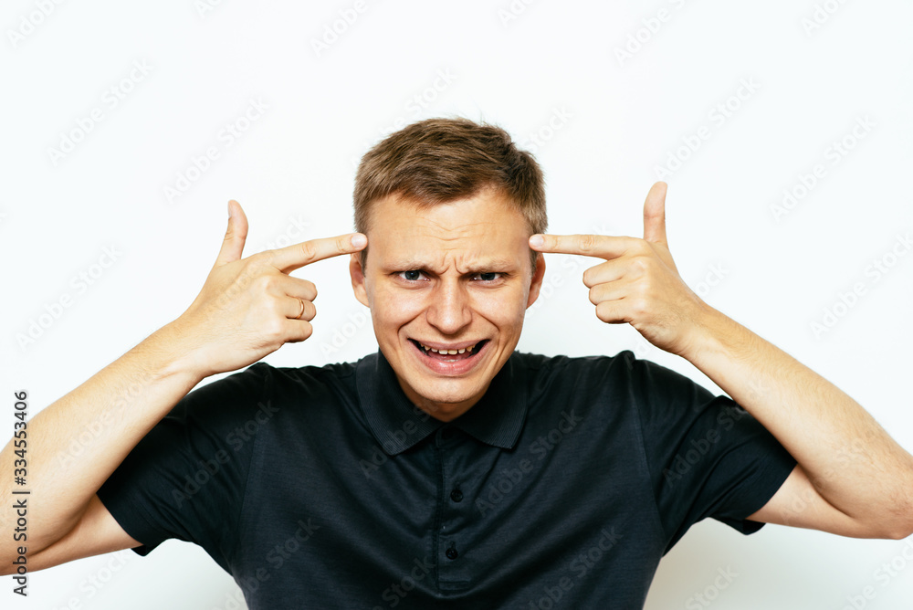 Closeup portrait of angry man gesturing with his finger against his temple, are you crazy? Closeup portrait of angry man gesturing with his finger against his temple, are you crazy?