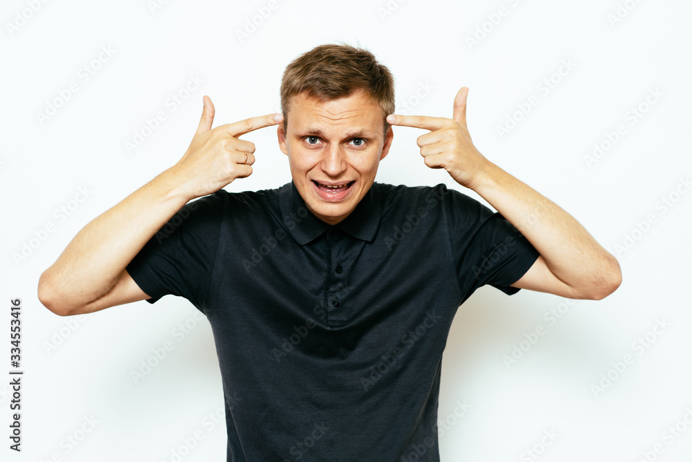 Closeup portrait of angry man gesturing with his finger against his temple, are you crazy? Closeup portrait of angry man gesturing with his finger against his temple, are you crazy?