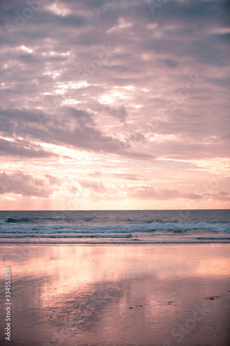 Pink and Blue  Cloudy Sky and Ocean with their Reflection on Wet Sands