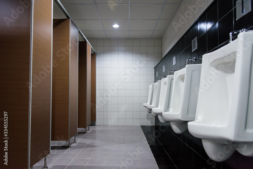 Newly interior toilet room with white urinals in the factory office