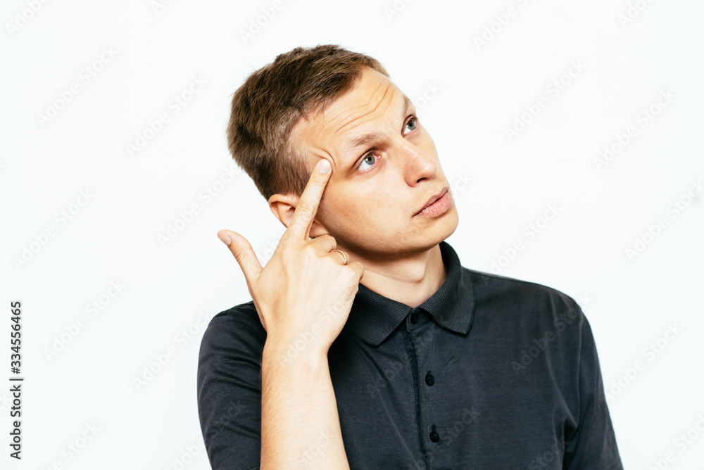 Closeup portrait of angry man gesturing with his finger against his temple, are you crazy? Closeup portrait of angry man gesturing with his finger against his temple, are you crazy?