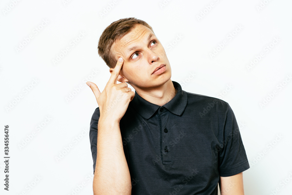 Closeup portrait of angry man gesturing with his finger against his temple, are you crazy? Closeup portrait of angry man gesturing with his finger against his temple, are you crazy?