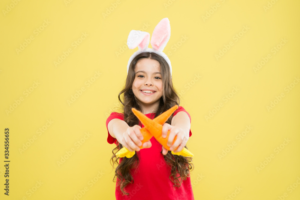 Having a healthy breakfast. good for your teeth. Nibbles carrot like hare. kid in rabbit ears eating carrot. child bunny costume with carrot. little happy girl food for rabbits. healthy childhood Having a healthy breakfast. good for your teeth. Nibbles carrot like hare. kid in rabbit ears eating carrot. child bunny costume with carrot. little happy girl food for rabbits. healthy childhood