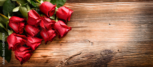 Red rose bouquet on vintage table banner. Roses on valentine day copy space f...