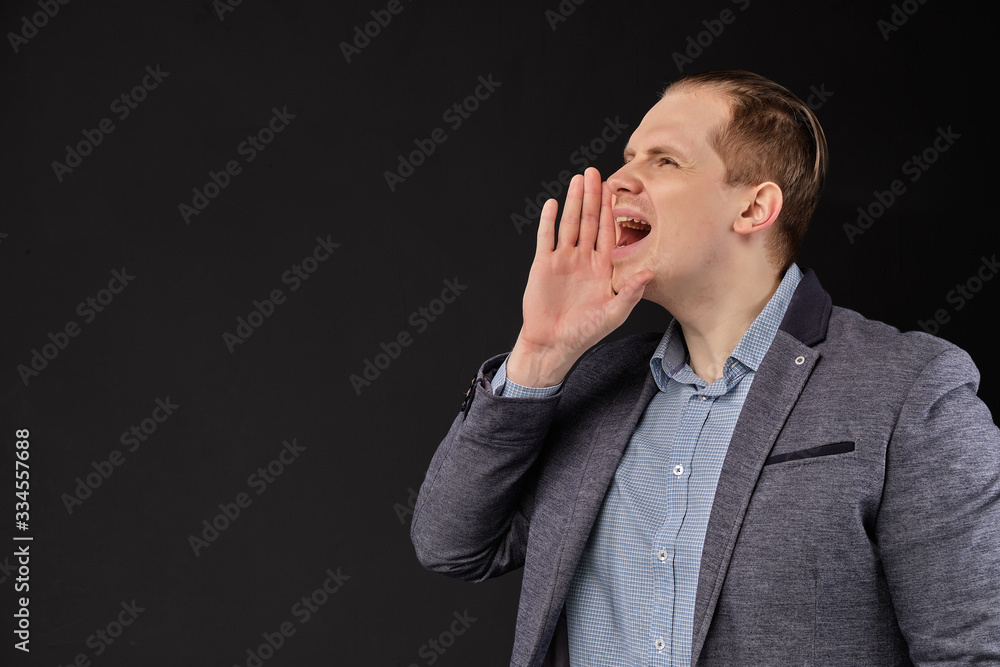 A man in a jacket makes an announcement on a black background. A man in a jacket makes an announcement on a black background.