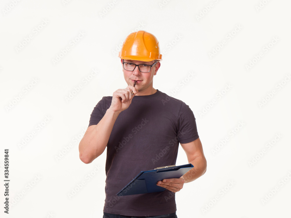 young man - worker in a helmet with a folder young man - worker in a helmet with a folder