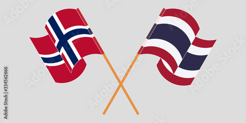 Crossed and waving flags of Norway and Thailand