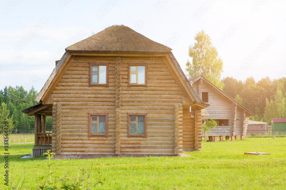 Two-story wooden house, summer and sun Two-story wooden house, summer and sun