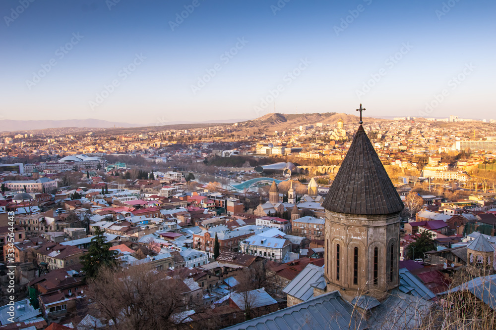 Tower of saint george's armenian cathedral in tbilisi with panoramic view of Georgia capital during the sunset.2020
