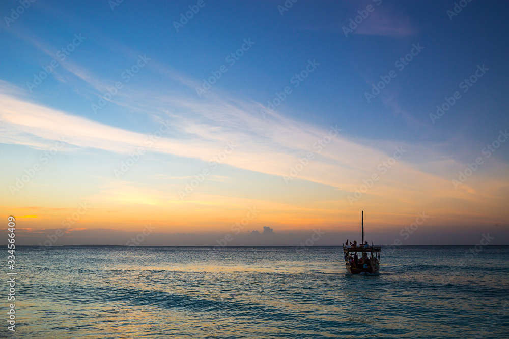 Boat on ocean surafe in evening